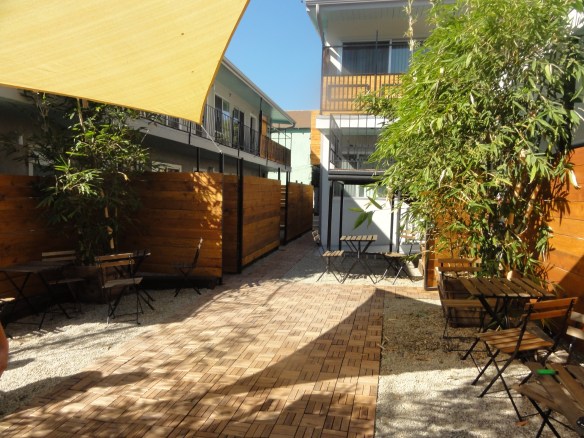 Part of the courtyard was fenced off to create private patios and create a cafe look into the public courtyard